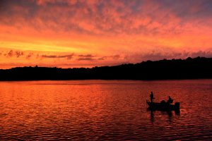 Sunset fisherman on Sweetwater Lake Indiana.