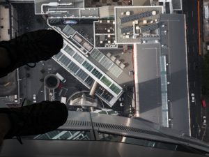 Looking straight down 56 stories through the glass floor in Auckland's Sky Tower